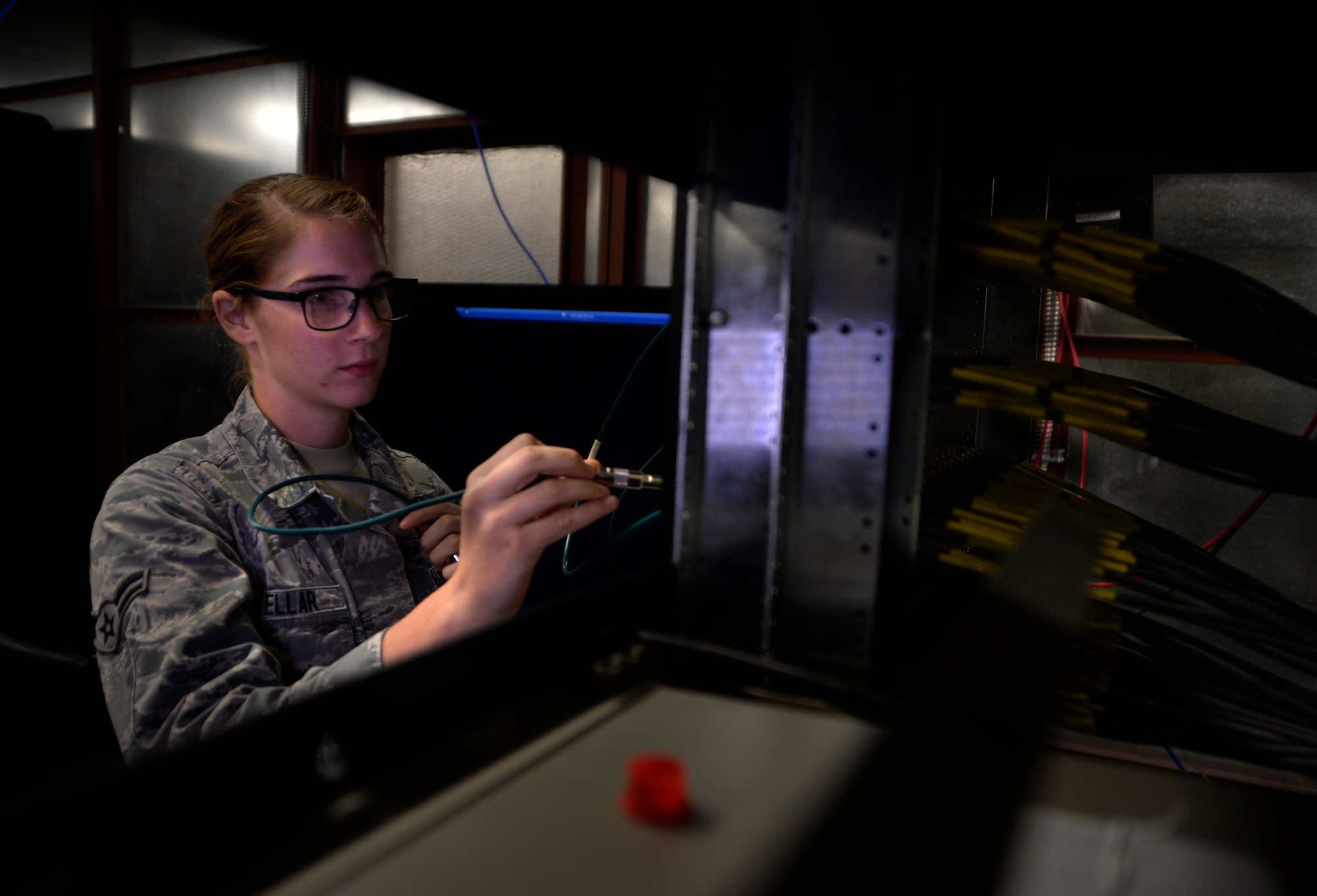 Airman 1st Class Ashley Kellar, 432nd Aircraft Communications Maintenance Squadron radio frequencies technician, patches in a ground control station for satellite link Aug. 19, 2015, at Creech Air Force Base, Nevada. The 432nd ACMS is the only unit in the Air Force dedicated to maintaining the communications network of the remotely piloted aircraft enterprise. (U.S. Air Force photo by Airman 1st Class Christian Clausen/Released)
