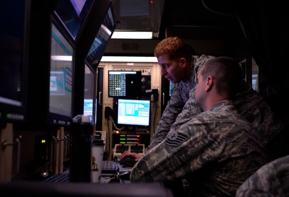 Tech. Sgt. Manuel Quiñones-Figuero, 432nd Aircraft Communication Maintenance Squadron NCO in-charge formal training unit, teaches Tech. Sgt. Thomas Diest, 432nd ACMS NCO -in-charge FTU, basic post-flight and procedures for the MQ-1 Predator and MQ-9 Reaper remotely piloted aircraft Aug. 19, 2015, at Creech Air Force Base, Nevada. The 432nd ACMS is the only unit of its kind in the Air Force dedicated to maintaining the communications network for the RPA enterprise. (U.S. Air Force photo by Airman 1st Class Christian Clausen/Released)