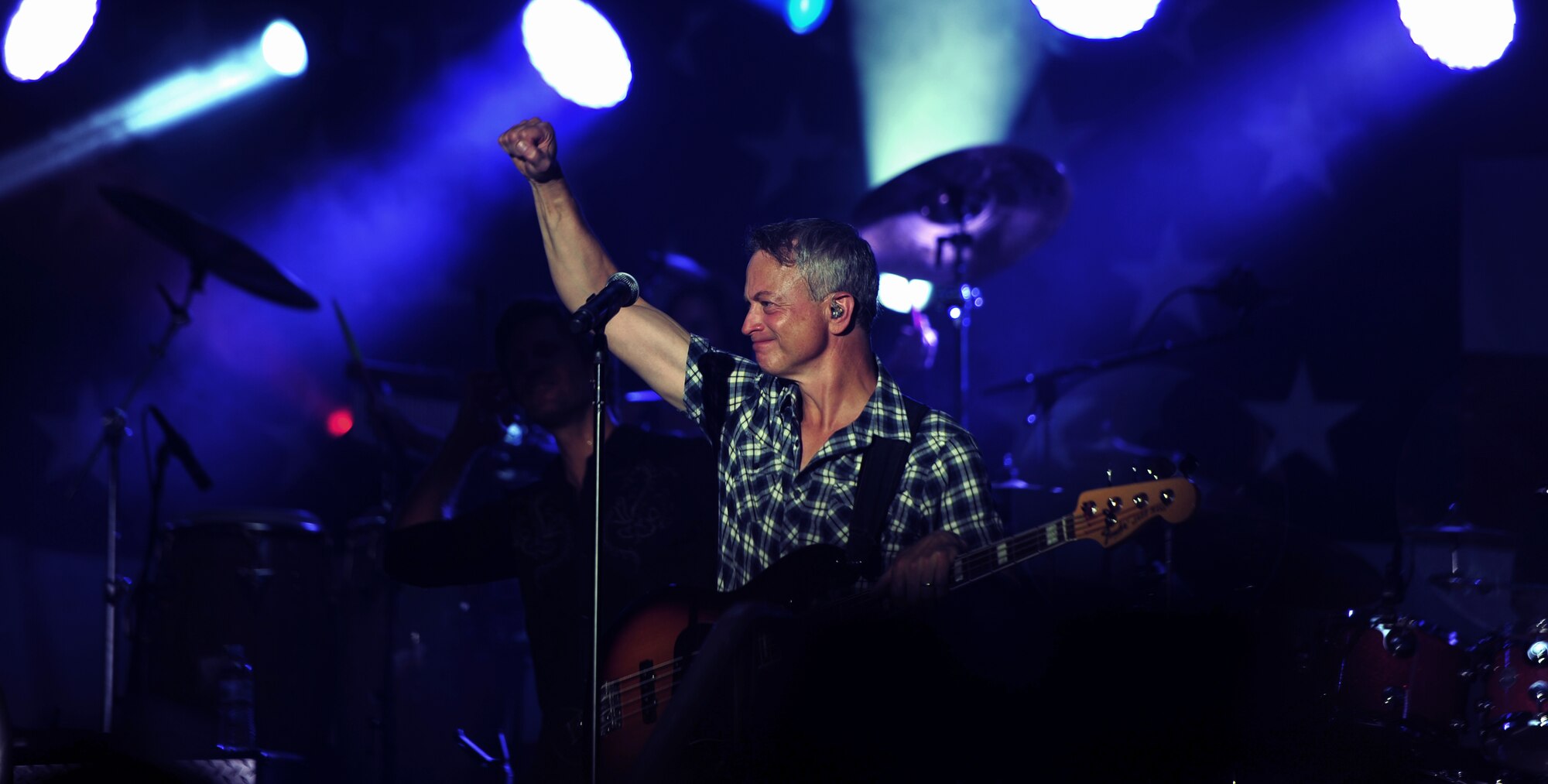 Gary Sinise, musician, founder of the Gary Sinise Foundation and actor, stops for a brief moment during his performance to pump up the crowd at Whiteman Air Force Base, Mo. Aug. 14, 2015. Sinise made his second visit to Whiteman since he began hosting concerts on military installations around the globe. 
(U.S. Air Force photo by Airman 1st Class Jovan Banks/Released)

