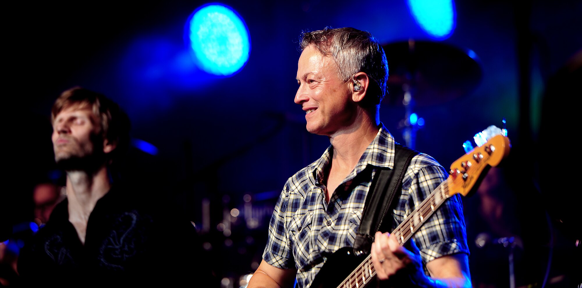 Gary Sinise, musician, founder of the Gary Sinise Foundation and actor, looks on to a cheering crowd during a concert at Whiteman Air Force Base, Mo. Aug. 14, 2015. The Lt. Dan Band performed approximately 24 songs ranging from the music of the 1980’s to present day hits. (U.S. Air Force photo by Airman 1st Class Jovan Banks/Released)