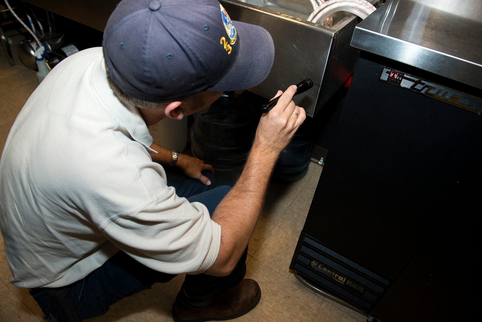 Bryon Kacprzyk, 23d Civil Engineer Squadron pest management supervisor, performs a pest inspection in the Moody Field Club Aug. 18, 2015, at Moody Air Force Base, Ga. The entomology shop performs monthly inspections in all food facilities on base to prevent pest problems from occurring. (U.S. Air Force photo by Airman 1st Class Kathleen D. Bryant)
