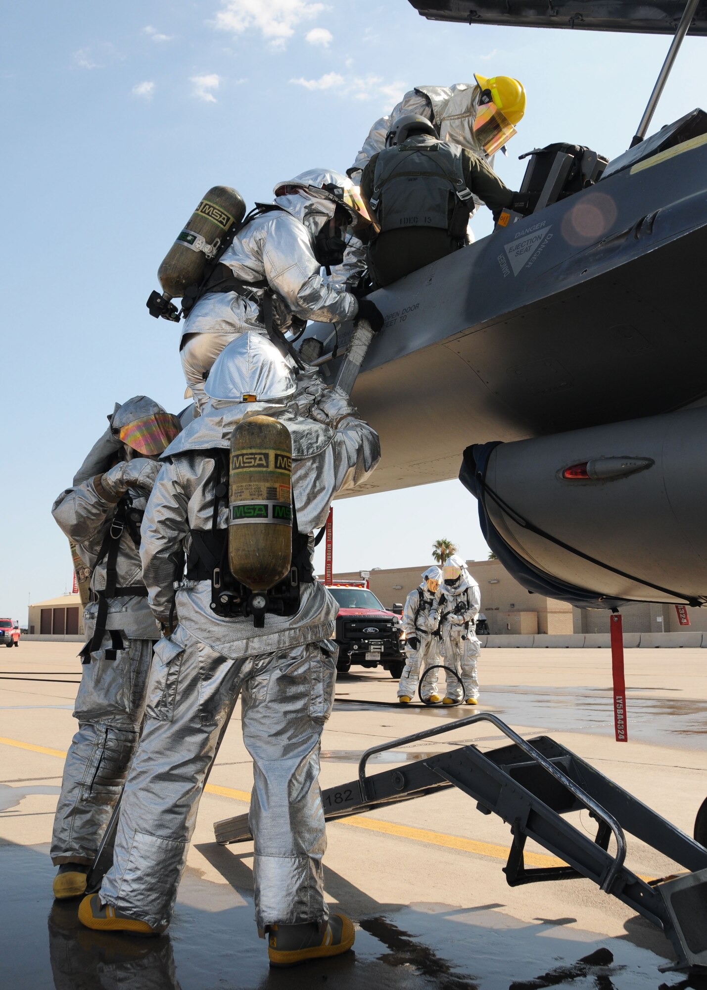 944th Fighter Wing Civil Engineering Squadron firefighters extract Maj. Peter Cossette, 944th Fighter Wing chief of inspections, during an aircrew extraction exercise at Luke Air Force Base, Ariz. (U.S. Air Force photo taken by Staff Sgt. Joshua Nason)