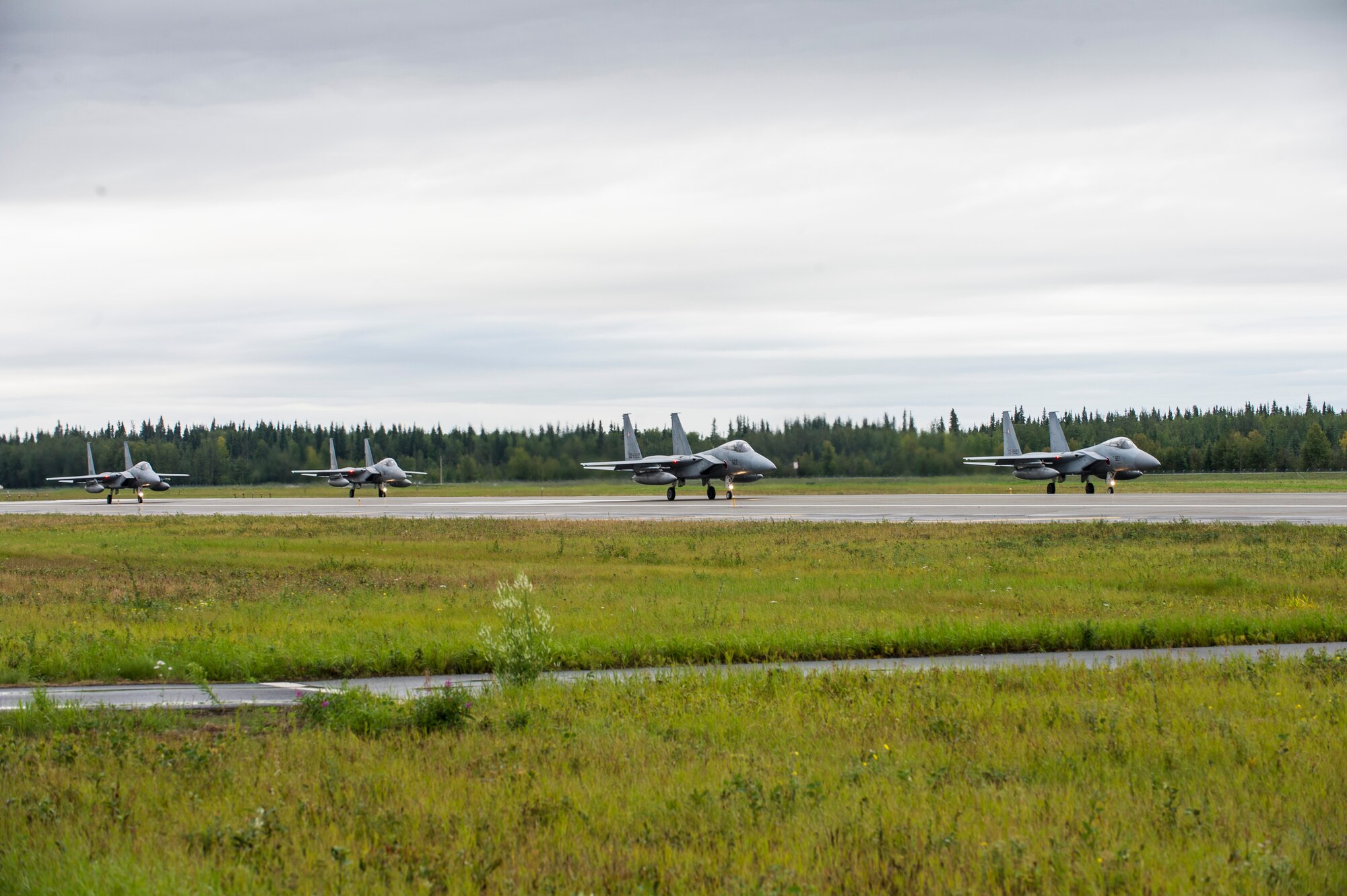 Four Japan Air Self-Defense Force (JASDF) F-15J Eagles prepare to take off from Eielson Air Force Base, Alaska, Aug. 20, 2015, during RED FLAG-Alaska (RF-A) 15-3. JASDF and Republic of Korea Air Force units are deployed to Eielson along with assorted aircraft and support personnel from multiple service branches for RF-A, a series of Pacific Air Forces commander-directed field training exercise for U.S. and partner nation forces, providing combined offensive counter-air, interdiction, close air support, and large force employment training in a simulated combat environment. (U.S. Air Force photo by Staff Sgt. Joshua Turner/Released)