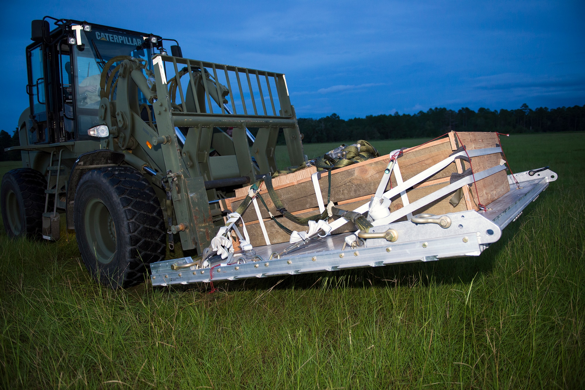 U.S. Air Force Staff Sgt. Michael Mendes, 347th Operations Support Squadron aerial delivery air transportation and loadmaster parachute rigger, forklifts a container delivery systems pallet during airdrop training Aug. 18, 2015, at Moody Air Force Base, Ga. Air transportation and loadmaster riggers  are responsible for directing 71st Rescue Squadron pilots to drop supplies such as food rations, water, and vehicles. (U.S. Air Force photo by Airman 1st Class Greg Nash/Released)