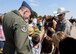 ALTUS AIR FORCE BASE, Okla. – U.S. Air Force Col. Todd Hohn, 97th Air Mobility Wing commander, speaks with children during the annual 17th-Annual Altus AFB Cattle Drive, Aug. 20, 2015. The cattle are driven approximately 3.5 miles through the base and housing. (U.S. Air Force photo by Airman 1st Class Megan E. Acs/Released) 