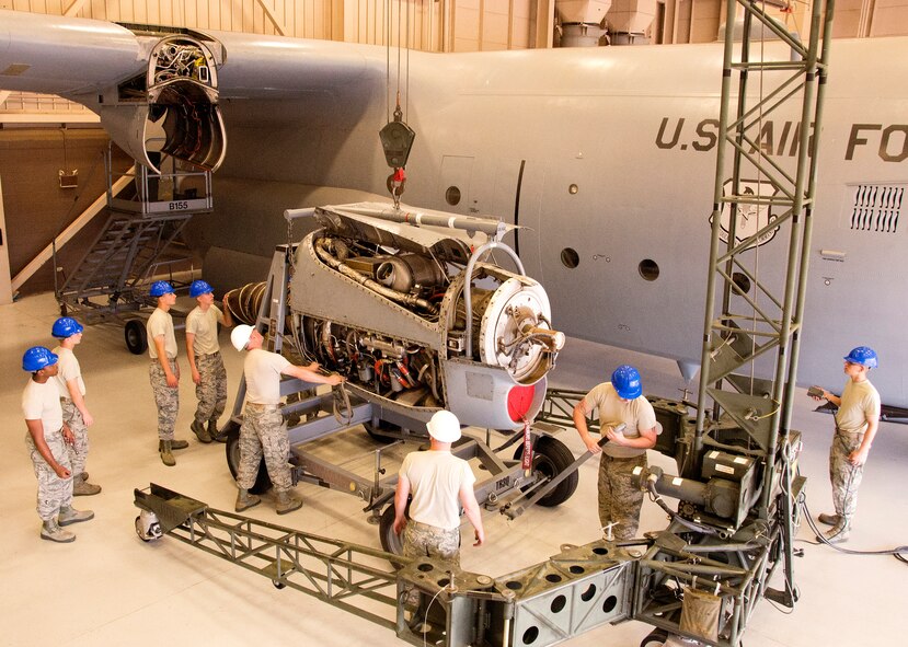 U.S. Air Force Staff Sgt. Justin Boyd, 361st Training Squadron instructor, demonstrates engine removal and installation on a C-130 Hercules by utilizing a 6,000 pound portable hoist crane Aug. 12, 2015, at Sheppard Air Force Base, Texas. This equipment is used to remove various types of engines for different aircraft, allowing Airmen to perform proper maintenance. (U.S. Air Force photo by Danny Webb/Released)