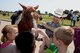 ALTUS AIR FORCE BASE, Okla. – U.S. Air Force Col. Terri Jones, 97th Mission Support Group commander, talks to children during a rest stop during the 17th-Annual Altus AFB Cattle Drive, Aug. 20, 2015. This is the 17th-Annual Altus AFB Cattle Drive, and kicks off the 38th-Annual Great Plains Stampede Rodeo. The rodeo ends on Saturday with Altus AFB Airmen unfurling a giant American flag during the opening ceremonies. (U.S. Air Force photo by Airman 1st Class Megan E. Acs/Released) 