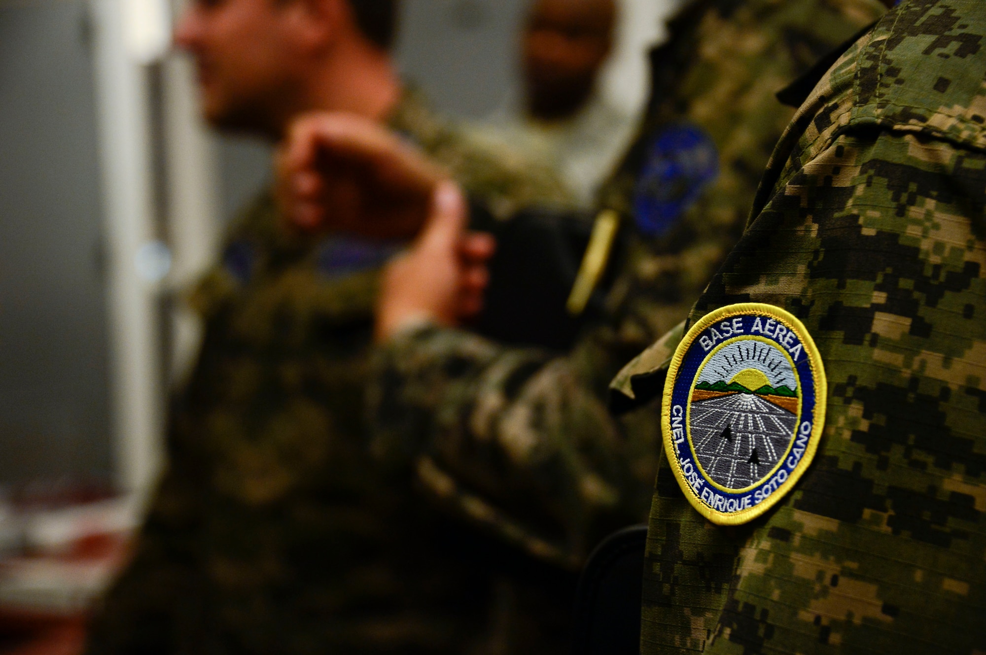 Members of the Honduran air force learn about the penetrant line during a subject matter expert exchange event with members from the 355th Equipment Maintenance Squadron nondestructive inspections lab on Davis-Monthan AFB, Ariz., Aug. 19, 2015. Penetrant is used to detect discontinuities, like cracks and pits that are open to the surface on parts made of nonporous materials. The penetrant enters into a surface discontinuity in the material and glows when exposed to UV light. The five members from the Honduran air force teamed up with 12th Air Force (Air Forces Southern) and the 355th EMS for a subject matter expert exchange that focused on a variety of nondestructive inspections lab processes and maintenance safety standards. (U.S. Air Force photo by Tech. Sgt. Heather Redman/Released)