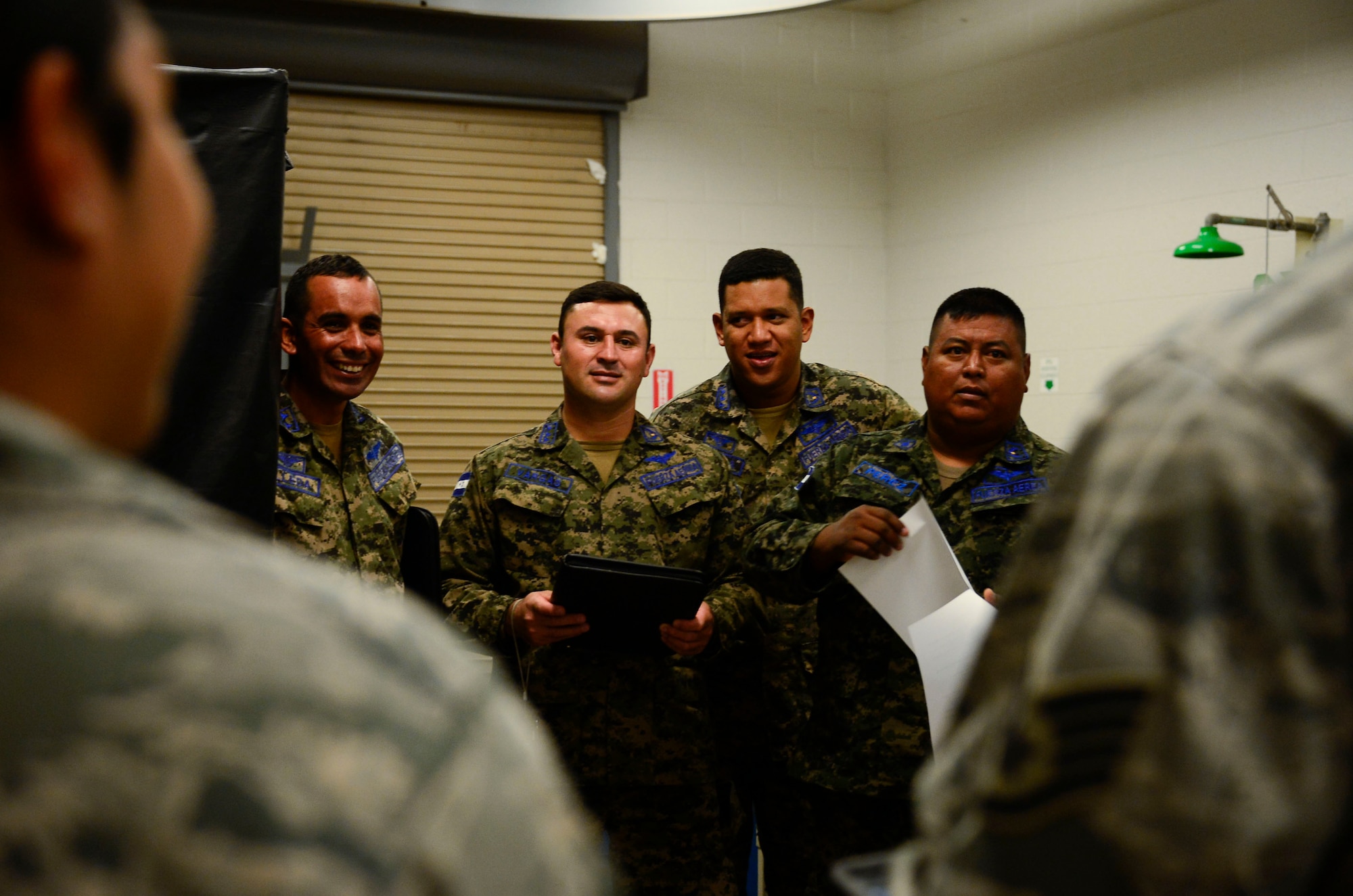 Members of the Honduran air force meet with the Airmen at the 355th Equipment Maintenance Squadron nondestructive inspections lab during a subject matter expert exchange event on Davis-Monthan AFB, Ariz., Aug. 19, 2015. Five members from the Honduran air force teamed up with 12th Air Force (Air Forces Southern) and the 355th EMS for a subject matter expert exchange that focused on a variety of nondestructive inspections lab processes and maintenance safety standards. (U.S. Air Force photo by Tech. Sgt. Heather Redman/Released)