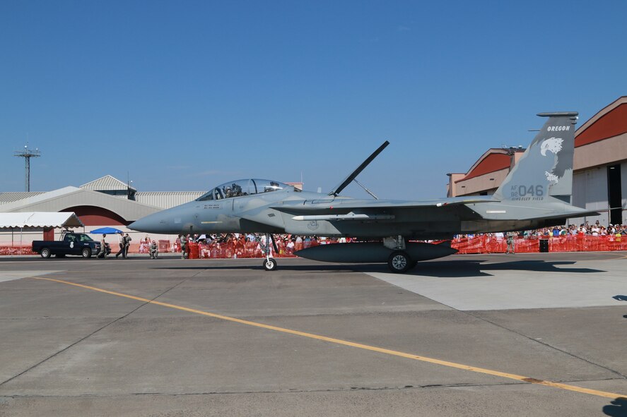 Members of the community watch as an F-15 Eagle from the 173rd Fighter Wing taxis by during a base open house held in conjunction with the Sentry Eagle exercise at Kingsley Field, Klamath Falls, Ore. Aug. 1, 2015.  Sentry Eagle is a multiforce exercise hosted by the 173rd Fighter Wing, Ore. ANG.  Multiple aircraft from across the country participate in the dissimilar air combat training over a four day period.  (U.S. Air National Guard photo by Master Sgt. Jennifer Shirar/released))