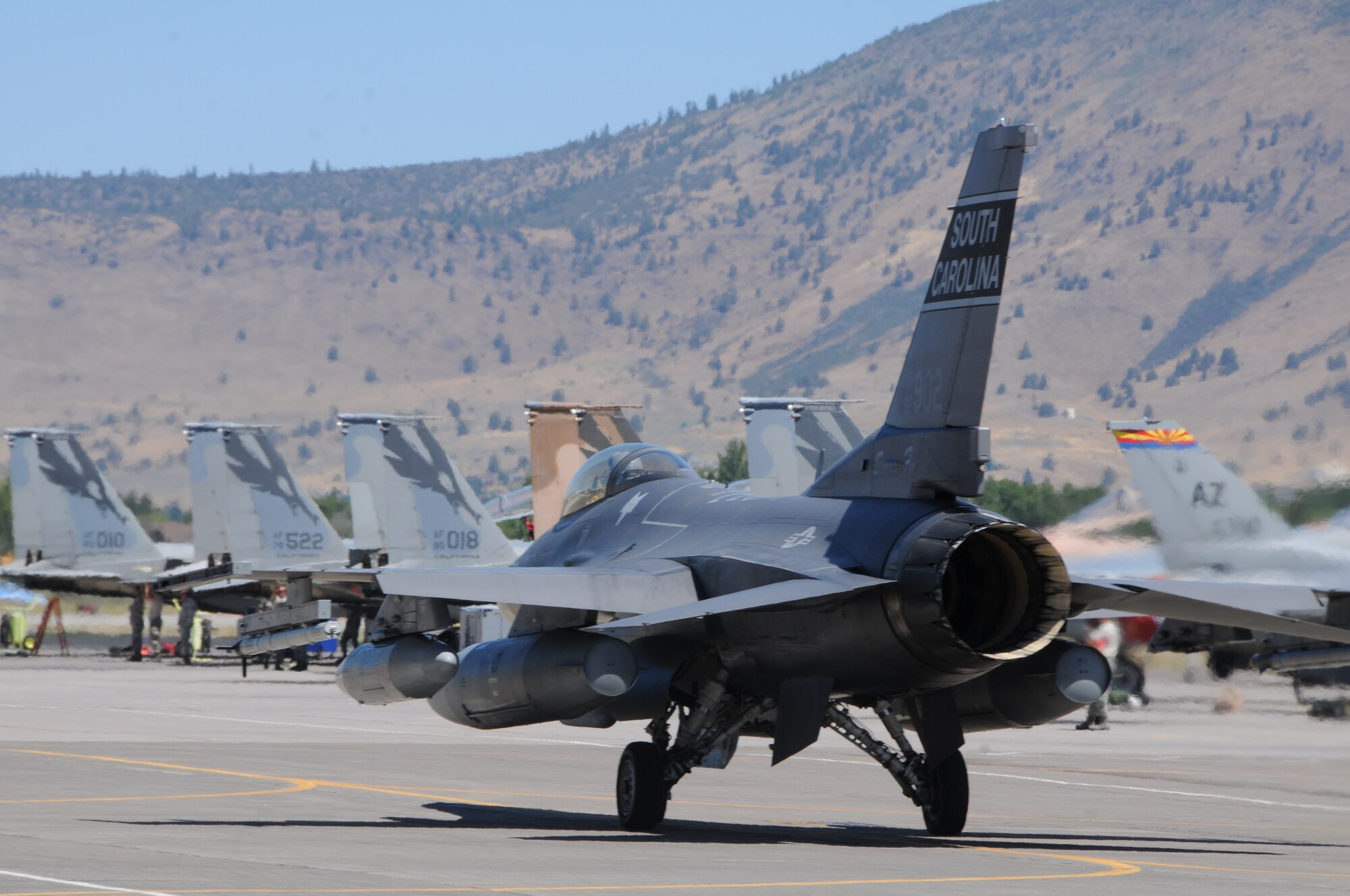 A U.S. Air Force F-16 from the South Carolina Air National Guard, 169th Fighter Wing, taxis past a ramp full of various aircraft following a training mission during the Sentry Eagle exercise July 29, 2015 at Kingsley Field, Ore.  Sentry Eagle is a multiforce exercise hosted by the 173rd Fighter Wing, Ore. ANG.  Multiple aircraft from across the country participate in the dissimilar air combat training over a four day period.  (U.S. Air National Guard photo by Senior Airman Penny Snoozy/released)