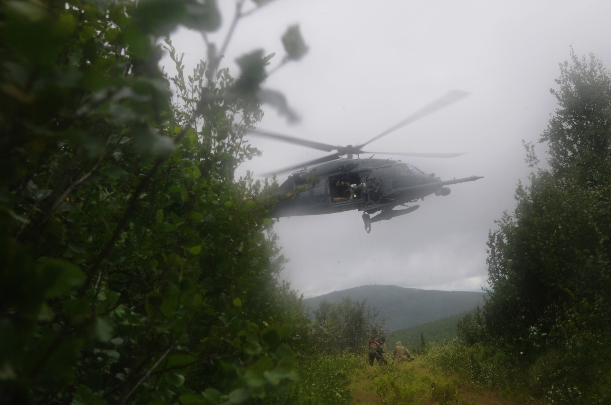 U.S. Air Force Airmen from the Alaska Air National Guard's 210th and 212th Rescue Squadrons rescue a pilot during an isolated personnel recovery exercise Aug. 13, 2015, at Eielson Air Force Base, Alaska, as part of RED FLAG-Alaska (RF-A) 15-3.  RF-A is a Pacific Air Forces commander-directed field training exercise for U.S. and partner nation forces, providing combined offensive counter-air, interdiction, close air support and large force employment training in a simulated combat environment.  (U.S. Air Force photo by Master Sgt. Ralph Kapustka/Released)