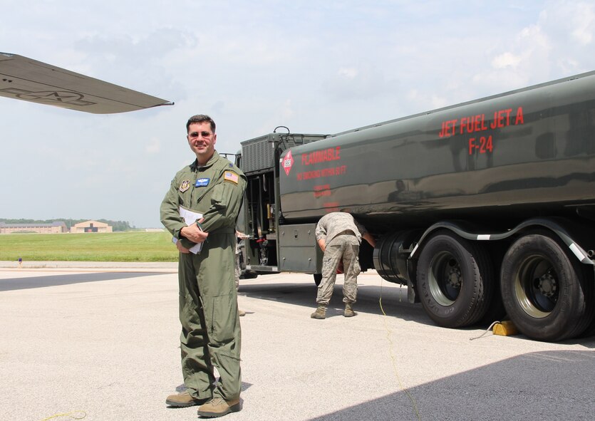 Pausing a moment before taking care of his next patient on the flightline, newly promoted Lt. Col. Paul Kowalczyk, 932nd Aeromedical Evacuation Squadron, enjoys a sunny day at Scott Air Force Base while the fuels personnel in the background prepare to refill a visiting C-130 aircraft with gas for the next leg of the plane’s trip.  The 932nd AES is part of the 932nd Airlift Wing, an Air Force Reserve Command unit which is located at Scott Air Force Base, Illinois.  (U.S. Air Force photo by Maj. Stan Paregien)