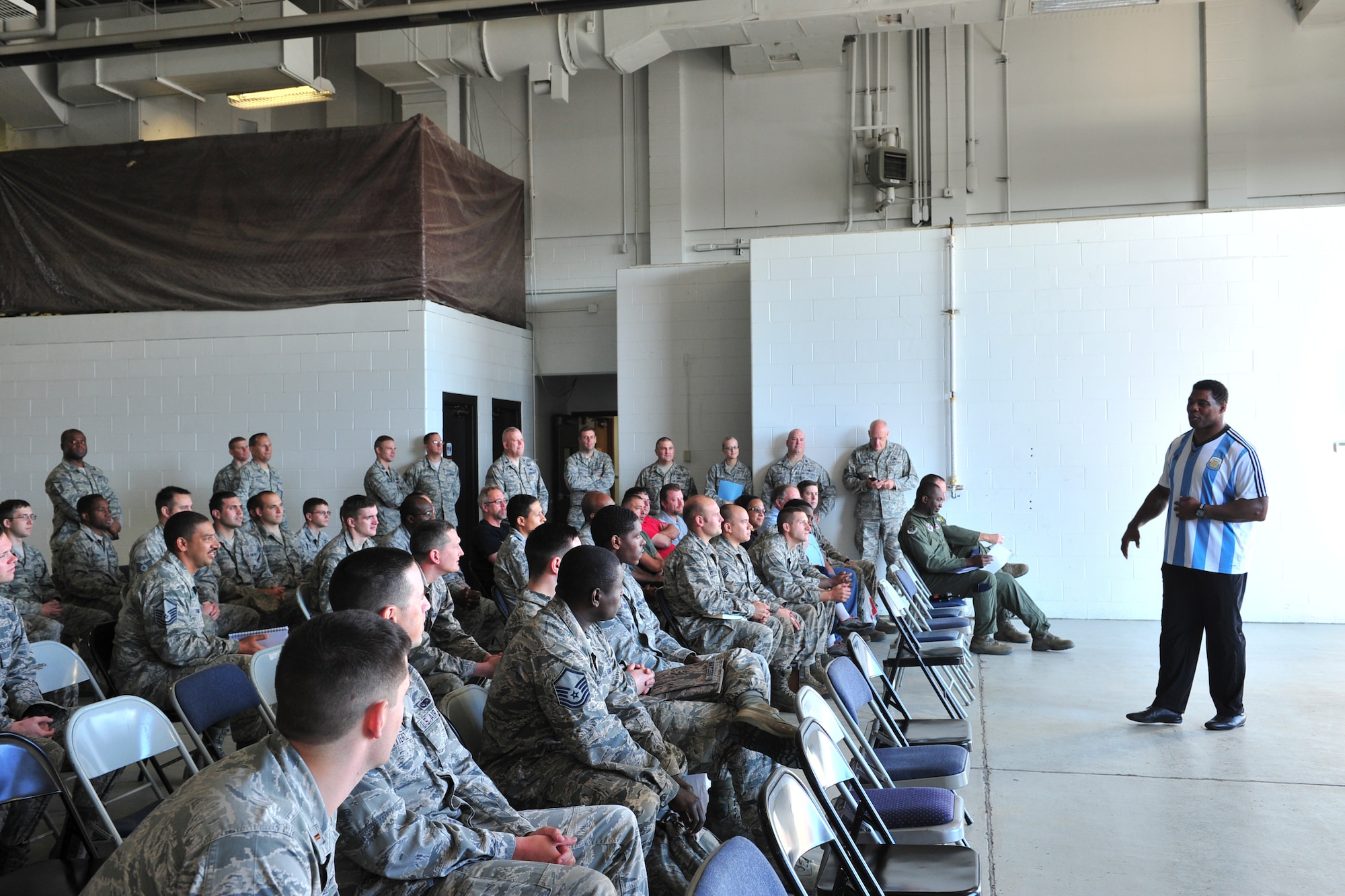 Herschel Walker talks to members from the 91st Maintenance Group about resiliency during his visit to Minot Air Force Base, N.D., Aug. 19, 2015. Walker shared stories about his battle with aggression, childhood bullies and his respect for the men and women of the United States military. (U.S. Air Force photo/Staff Sgt. Malia Jenkins) 