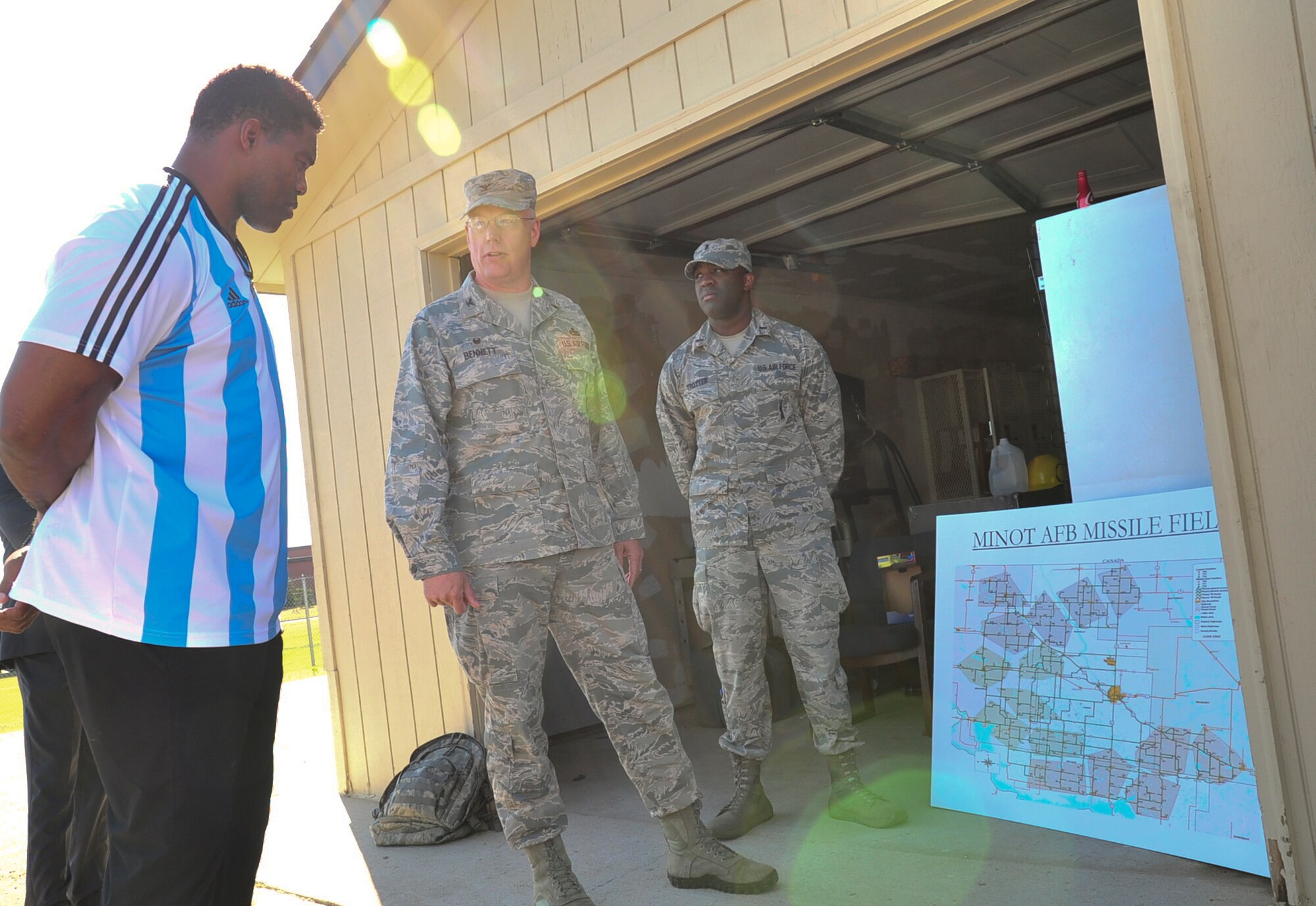 Herschel Walker sees the layout of the missile field from Col. Earl Bennett Jr., 91st Missile Maintenance Group commander, during his visit to Minot Air Force Base, N.D., Aug. 19, 2015. Walker shared stories about his battle with aggression, childhood bullies and his respect for the men and women of the United States military. Walker is a retired professional football player and while at the University of Georgia, was awarded the Heisman Trophy in 1982. (U.S. Air Force photo/Staff Sgt. Malia Jenkins)