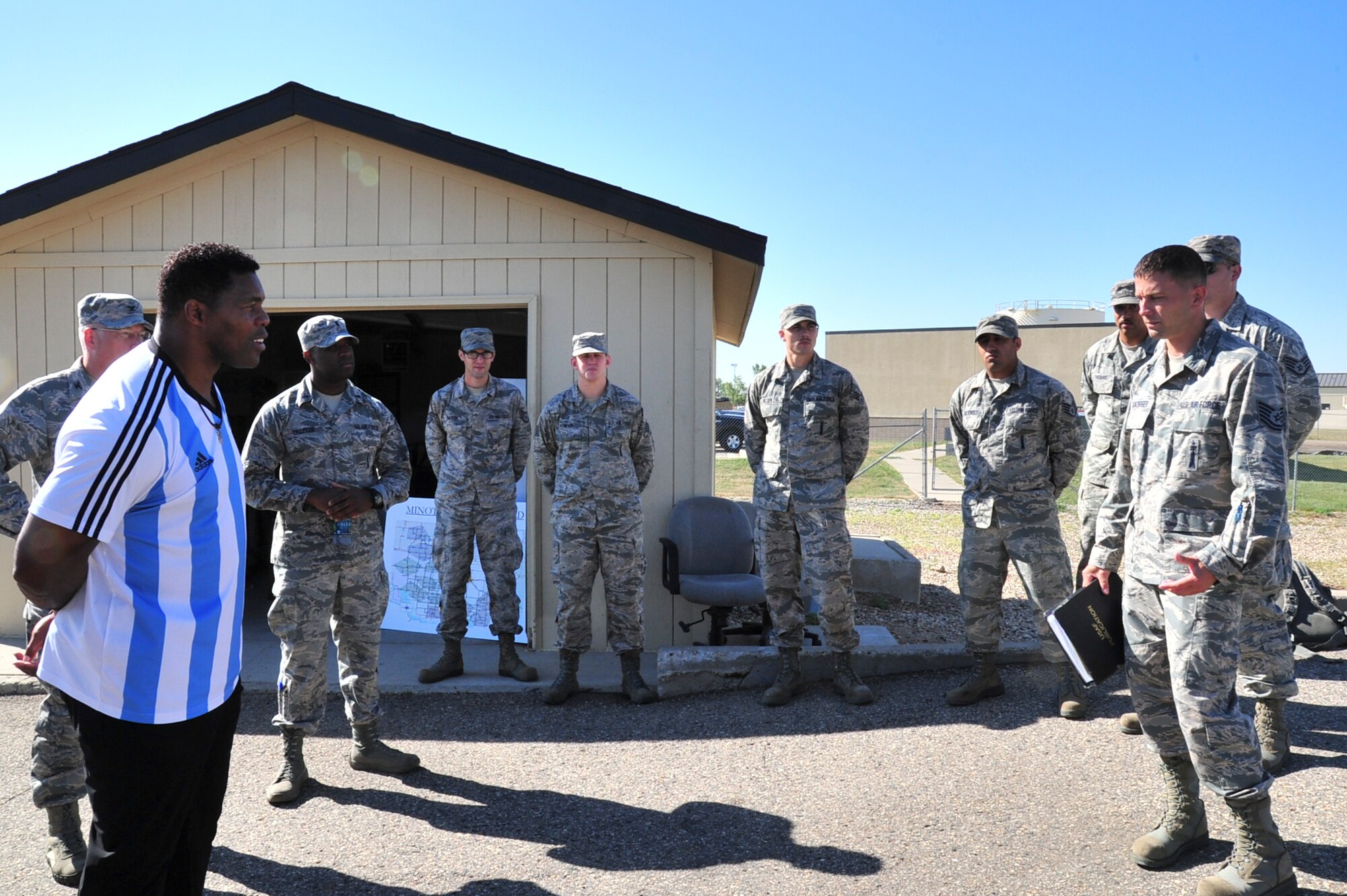Herschel Walker learns about a launch facility and operator’s mission during his visit to Minot Air Force Base, N.D., Aug. 19, 2015. Walker shared stories about his battle with aggression, childhood bullies and his respect for the men and women of the United States military. (U.S. Air Force photo/Staff Sgt. Malia Jenkins)
