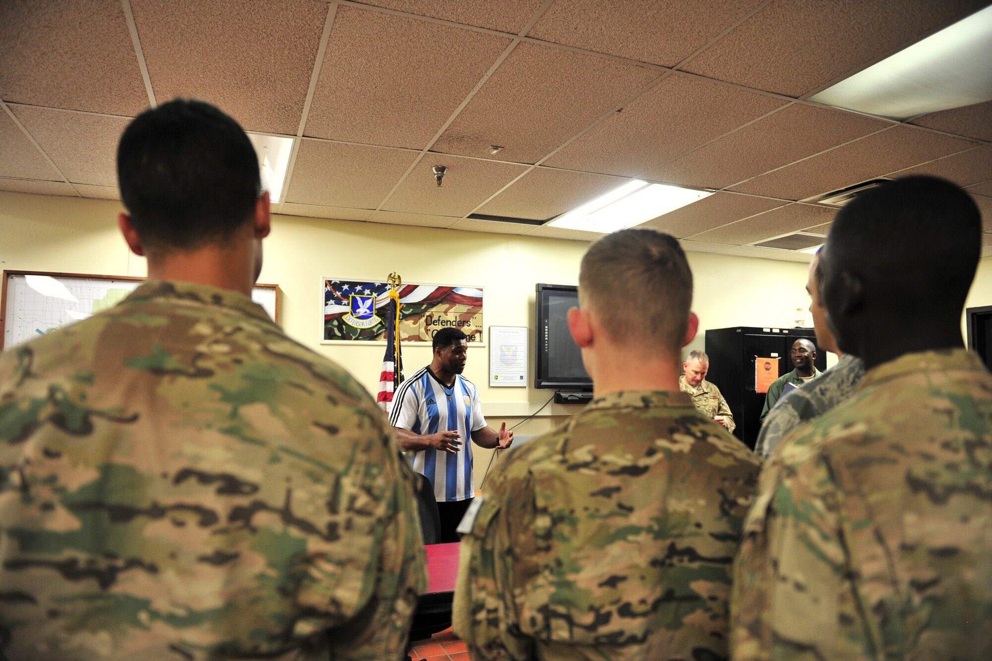 Herschel Walker talks to members from the 91st Security Forces Group about resiliency during his visit to Minot Air Force Base, N.D., Aug. 19, 2015. Walker shared stories about his battle with aggression, childhood bullies and his respect for the men and women of the United States military. Walker is a retired professional football player and while at the University of Georgia, was awarded the Heisman Trophy in 1982. (U.S. Air Force photo/Staff Sgt. Malia Jenkins) 