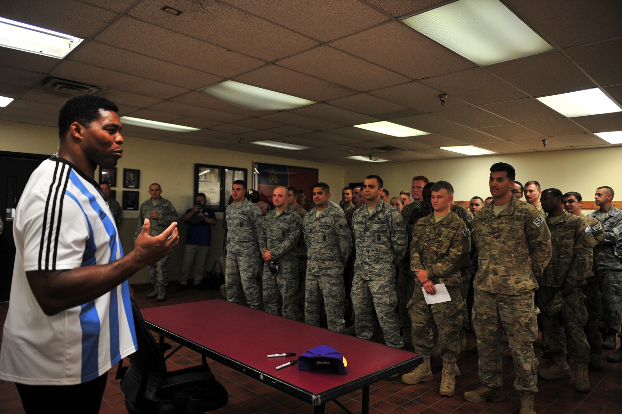Herschel Walker talks to members from the 91st Security Forces Group about resiliency during his visit to Minot Air Force Base, N.D., Aug. 19, 2015. Walker shared stories about his battle with aggression, childhood bullies and his respect for the men and women of the United States military. Walker is a retired professional football player and while at the University of Georgia, was awarded the Heisman Trophy in 1982. (U.S. Air Force photo/Staff Sgt. Malia Jenkins) 