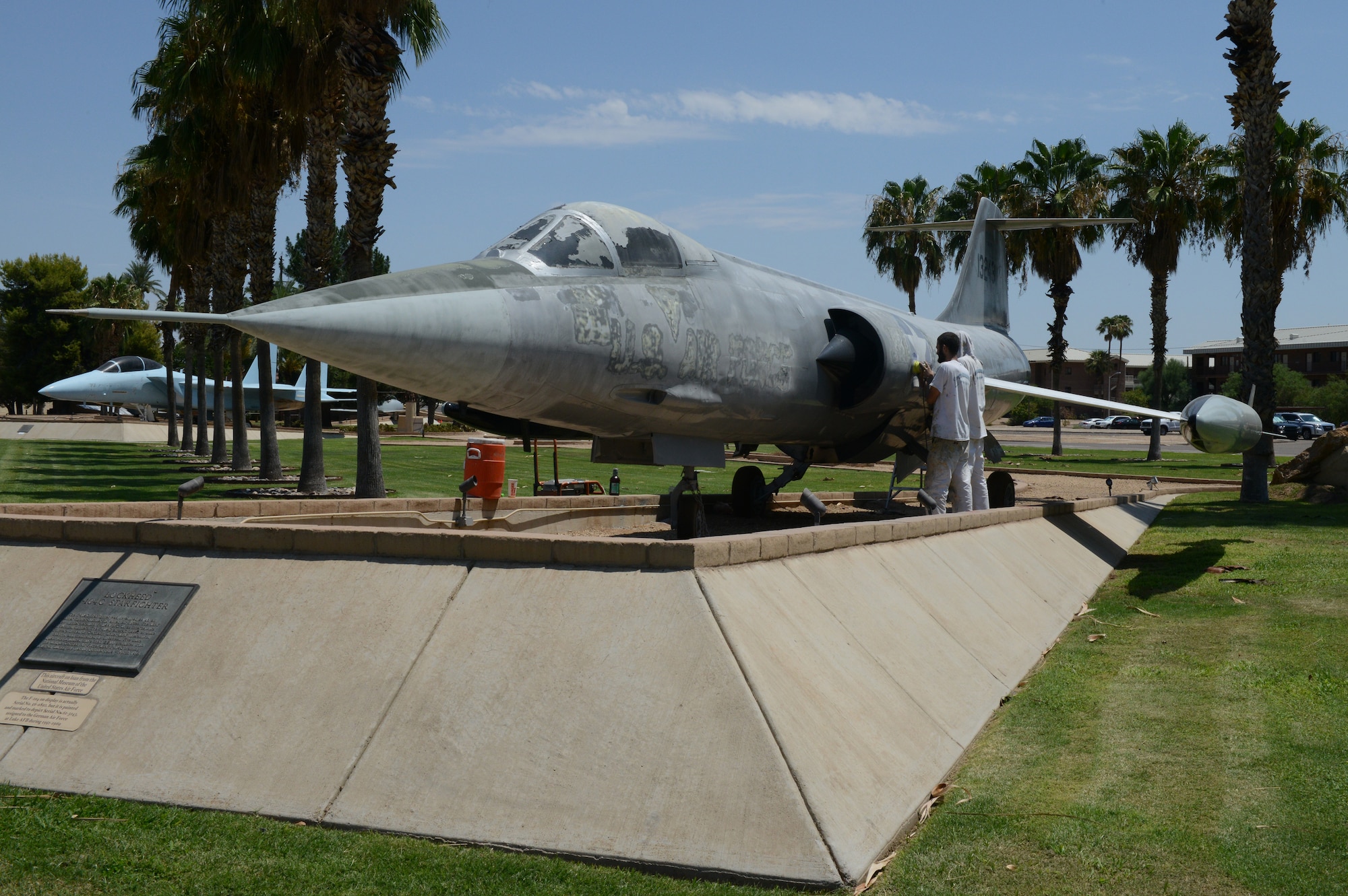 James Bridges and Hayden Yager, civilian contractors, prepare the F-104C Starfighter static display for painting at Luke Air Force Base, Arizona, Aug. 12, 2015. All the static displays in the airpark will be repainted and have maintenance performed by the end of the year. (U.S. Air Force photo by Senior Airman James Hensley)