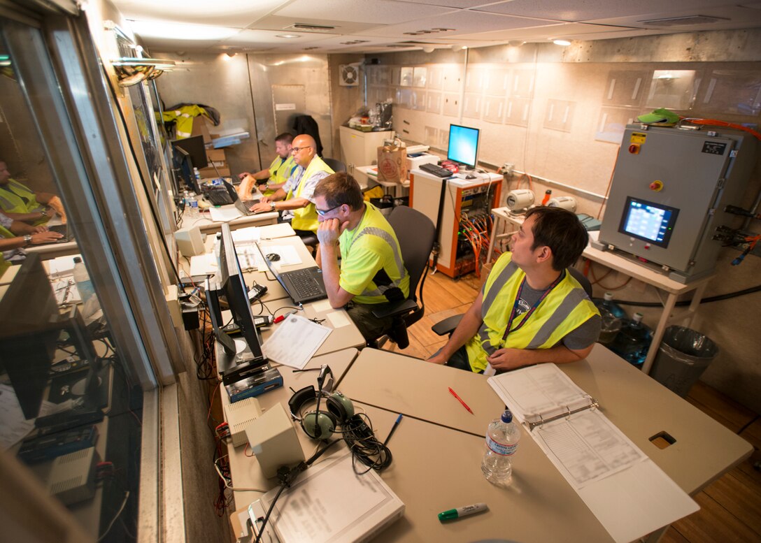 Test conductors watch for pressure spikes in a custom built Boeing test trailer during KC-10 fuel surge testing Aug. 8. (U.S. Air Force photo by Brad White)