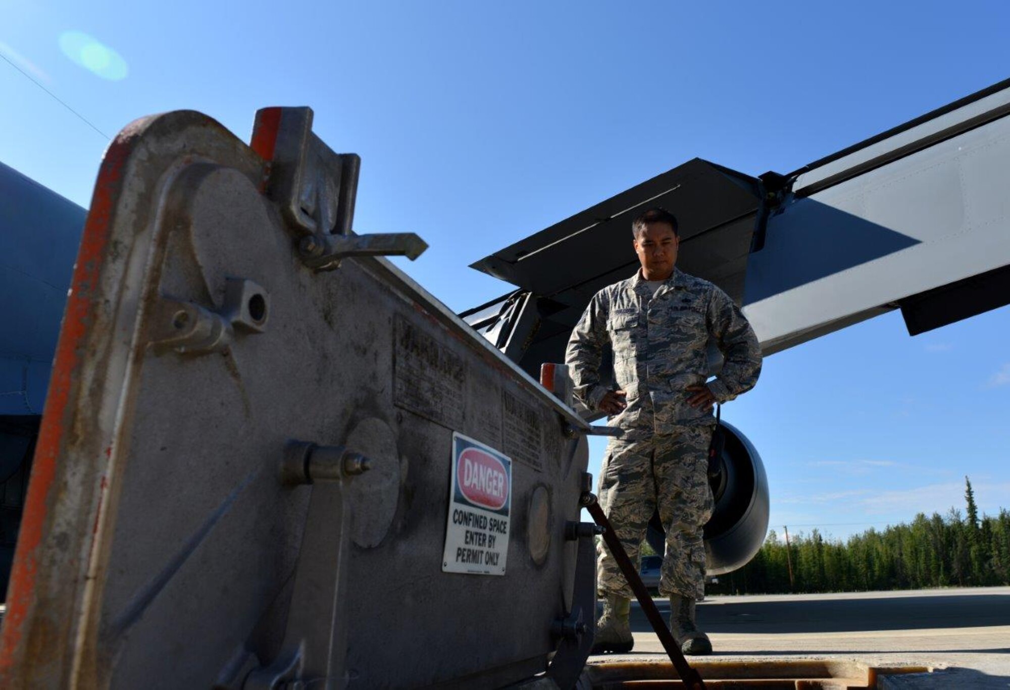 U.S. Air Force Tech. Sgt. Archie Obiacoro, a 354th Logistics Readiness Squadron petroleum, oils, lubrication fuels operations section chief, examines an R-12 fuel connection point by a U.S. Air Force KC-135 assigned to the 92nd Air Refueling Wing, Fairchild Air Force Base, Wash., on the Eielson Air Force Base, Alaska, flightline Aug. 14, 2015. R-12 fuel trucks hook up to placements like this one and funnel fuel directly from the pipeline into the aircraft, eliminating the need to refuel a truck tank on the way. (U.S. Air Force photo by Airman 1st Class Kyle Johnson)