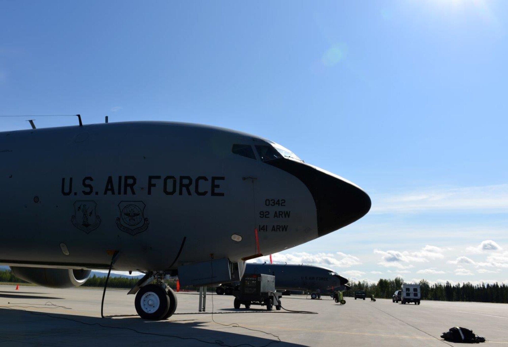 A U.S. Air Force KC-135 assigned to the 92nd Air Refueling Wing, Fairchild Air Force Base, Wash., waits with other refuelers as maintainers go through checklists and trucks ferry airmen one way or another on the Eielson Air Force Base, Alaska, flightline Aug. 14, 2015. These refuelers, and many like them, come on a temporary duty assignment from a variety of locations to support RED FLAG-Alaska 15-3, a Pacific Air Forces commander-directed field training exercise for U.S. and partner nation forces, providing combined offensive, counter-air, interdiction, close-air support, and large-force employment training in a simulated combat environment.(U.S. Air Force photo by Airman 1st Class Kyle Johnson)