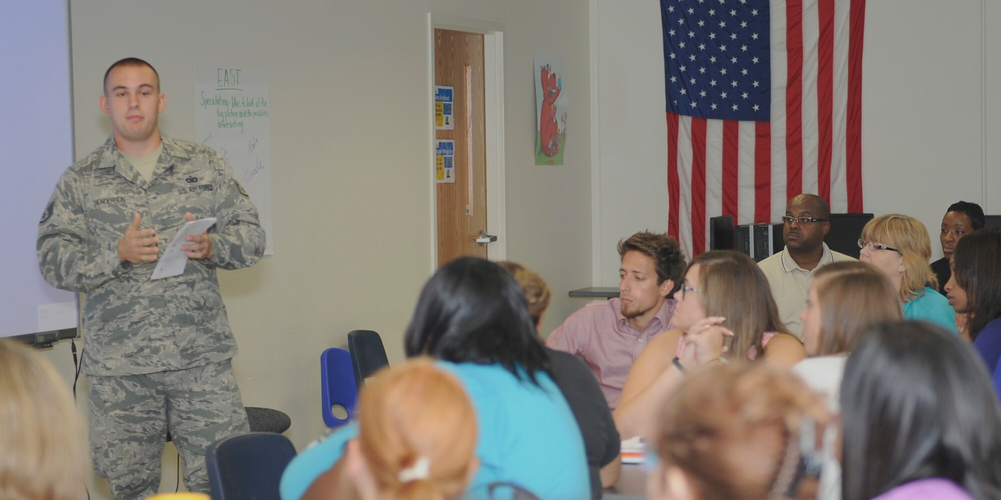 Staff Sgt. Journey Henderson, 11th Security Support Squadron response force leader, briefs active-shooter response techniques to teachers and staff at Imagine Andrews Public Charter School Aug. 20, 2015, at Joint Base Andrews, Md. Knowing how to respond throughout the course of a crisis is key to survival. (U.S. Air Force photo by Senior Airman Preston Webb/RELEASED)