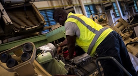 Anthony Moore, a mechanic with the Army Strategic Logistics Activity – Charleston, does maintenance on a M113 Armored Personnel Carrier Aug. 20, 2015 at Joint Base Charleston, S.C. ASLAC provides the U.S. warfighter the ability to quickly generate combat power at any location designated by the National Command Authority by establishing, maintaining and reconstituting Army Prepositioned Stocks Afloat. (U.S. Air Force photo/Airman 1st Class Clayton Cupit)