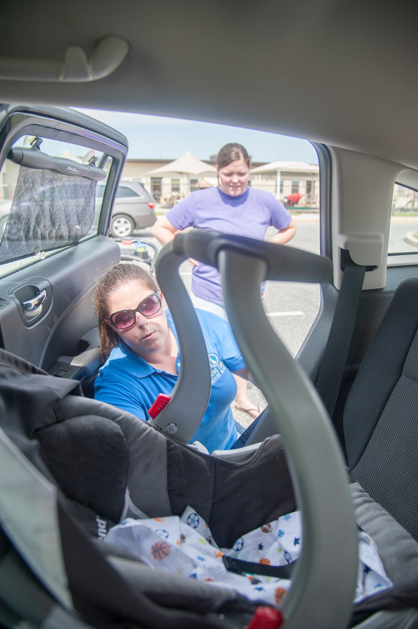 Lindsay Andersen, Delaware Office of Highway Safety fitting station coordinator, shows Nichole McDannell, 436th Aerospace Medicine Squadron member and parent of 2-year-old Max and 2-month-old Kyle, the correct recline angle for a model infant car seat Aug. 18, 2015, at the Child Development Center on Dover Air Force Base, Del. The proper recline angle is important because of the possibility for newborn and young children’s airways to be blocked if they sit too upright. (U.S. Air Force photo/Senior Airman Jared Duhon)
