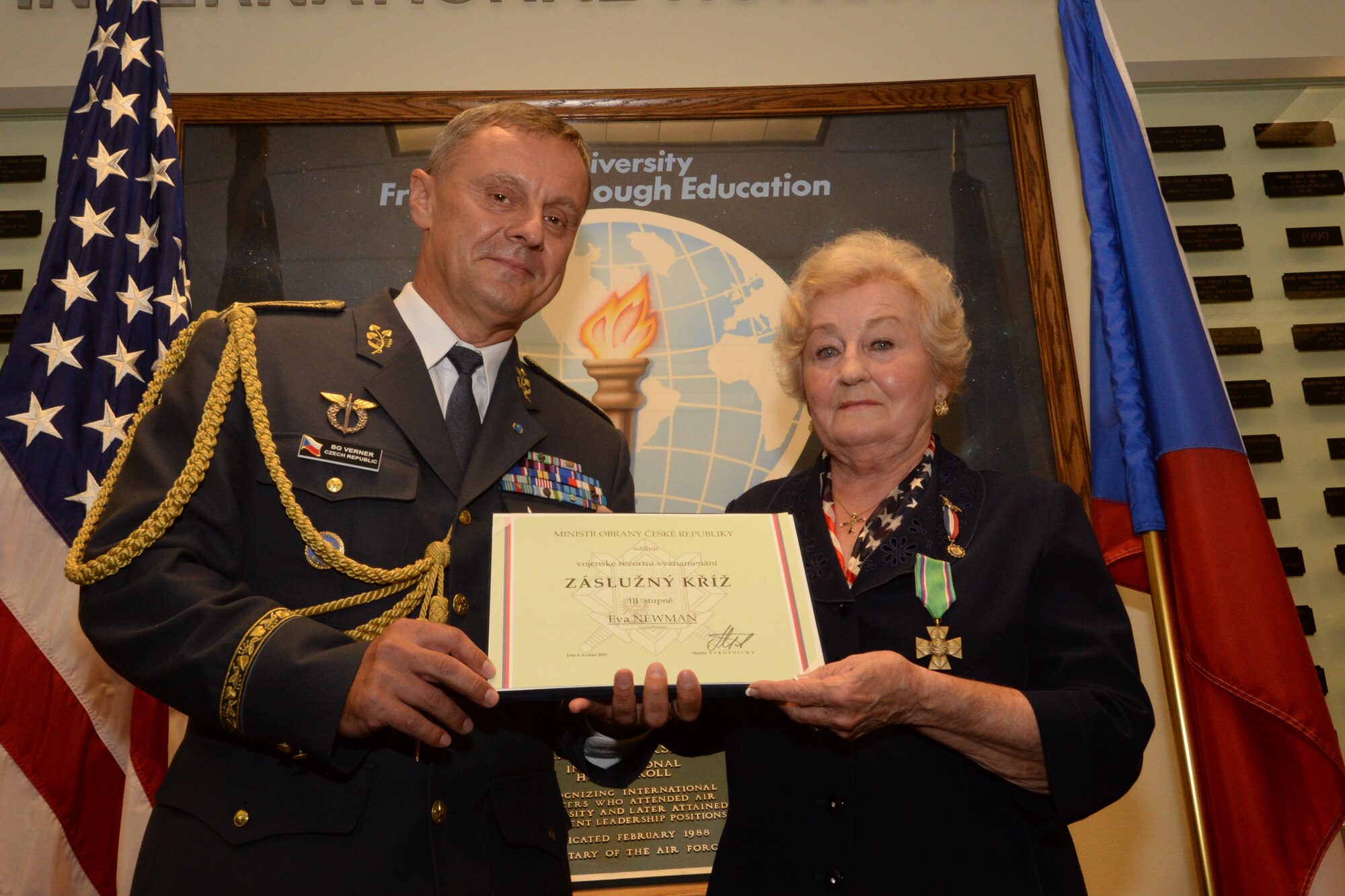 Czech Republic Defense Attaché Brig. Gen. Jiri Verner presents the Czech Republic Medal of Merit to Eva Newman, an Alabama Goodwill Ambassador, Aug. 19, 2015, at Air University’s International Officer School, Maxwell Air Force Base, Ala. Newman received the award for 18 years of sponsorship of Czech Republic military officers who attend Air University colleges and schools. Newman was raised in Czechoslovakia during World War II and immigrated to the United States in 1951. (U.S. Air Force photo by Airman 1st Class Alexa Culbert) 