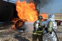 A Del Rio city firefighter, left, attempts to suppress the flames, while a Laughlin firefighter provides assistance during an aircraft live-fire training exercise on Laughlin Air Force Base, Texas, Aug. 19, 2015. The Del Rio Fire Department participates in the “aircraft live-fire” training exercise at least once a year, and the training is designed to familiarize firefighters with the techniques used in an aircraft fire. (U.S. Air Force photo by Airman 1st Class Brandon May)(Released)