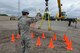 Staff Sgt. Austin Kemmer, of the 119th Civil Engineer Squadron, left, provides hand signals for Staff Sgt. Blake Robinson, of the 137th Civil Engineer Squadron, as he manipulates a concrete barrier into a target area using a crane as they train at the North Dakota Air National Guard Regional Training Site, Fargo, North Dakota, August 19, 2015. The North Dakota Air National Guard Regional Training Site is one of five contingency training locations in the United States used by Air National Guard and U.S. Air Force personnel in the civil engineer career fields. I provides wartime mission training as well as proficiency training on construction practices, utility support, emergency services, maintenance and repair of base infrastructure. Four separate groups totaling about 400 people are scheduled to train at the site in the month of August in 2015. (U.S. Air National Guard photo by Senior Master Sgt. David H. Lipp/Released)