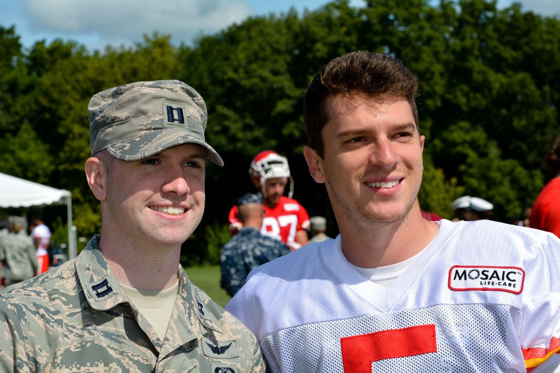 Capt. Ben Hedley, member of the 241st Air Traffic Control Squadron, takes a photo with Cairo Santos, kicker for the Kansas City Chiefs, during the Chiefs training camp at Missouri Western University in St. Joseph, Mo., on Aug. 19, 2015. (U.S. Air National Guard photo by Senior Airman Bruce Jenkins)