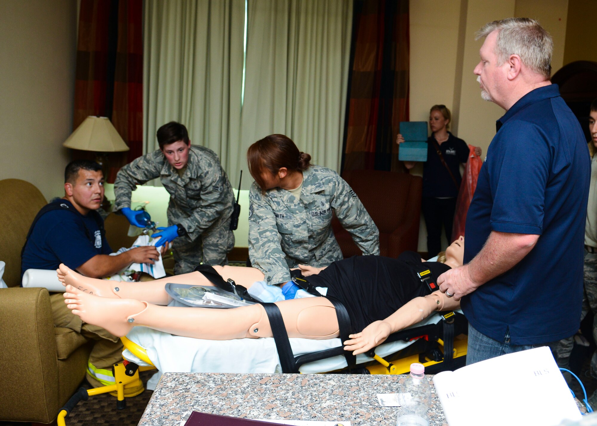 (Right) Gene Bryan, 31st Medical Group medical simulation coordinator, facilitates a simulated birth exercise, Aug. 13, 2015, at Aviano Air Base, Italy. The medical simulation team focuses on joint exercises between medical group, security forces, fire department and other responders. (U.S. Air Force photo by Senior Airman Austin Harvill/Released)