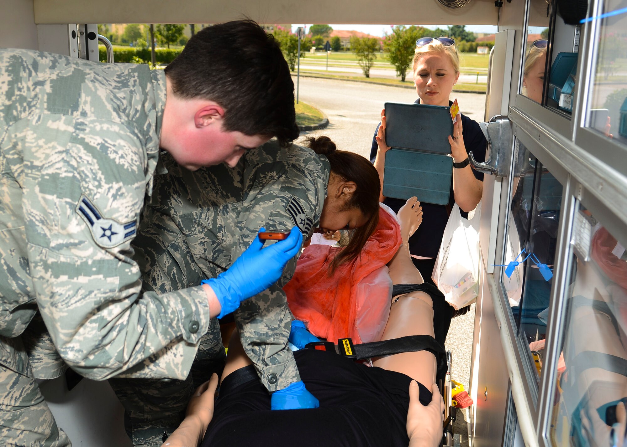 Missy Hanley, 31st Medical Group medical simulation operator, records a simulated birth exercise, Aug. 13, 2015, at Aviano Air Base, Italy. The medical simulation team creates complex training scenarios for the entire medical group. (U.S. Air Force photo by Senior Airman Austin Harvill/Released)