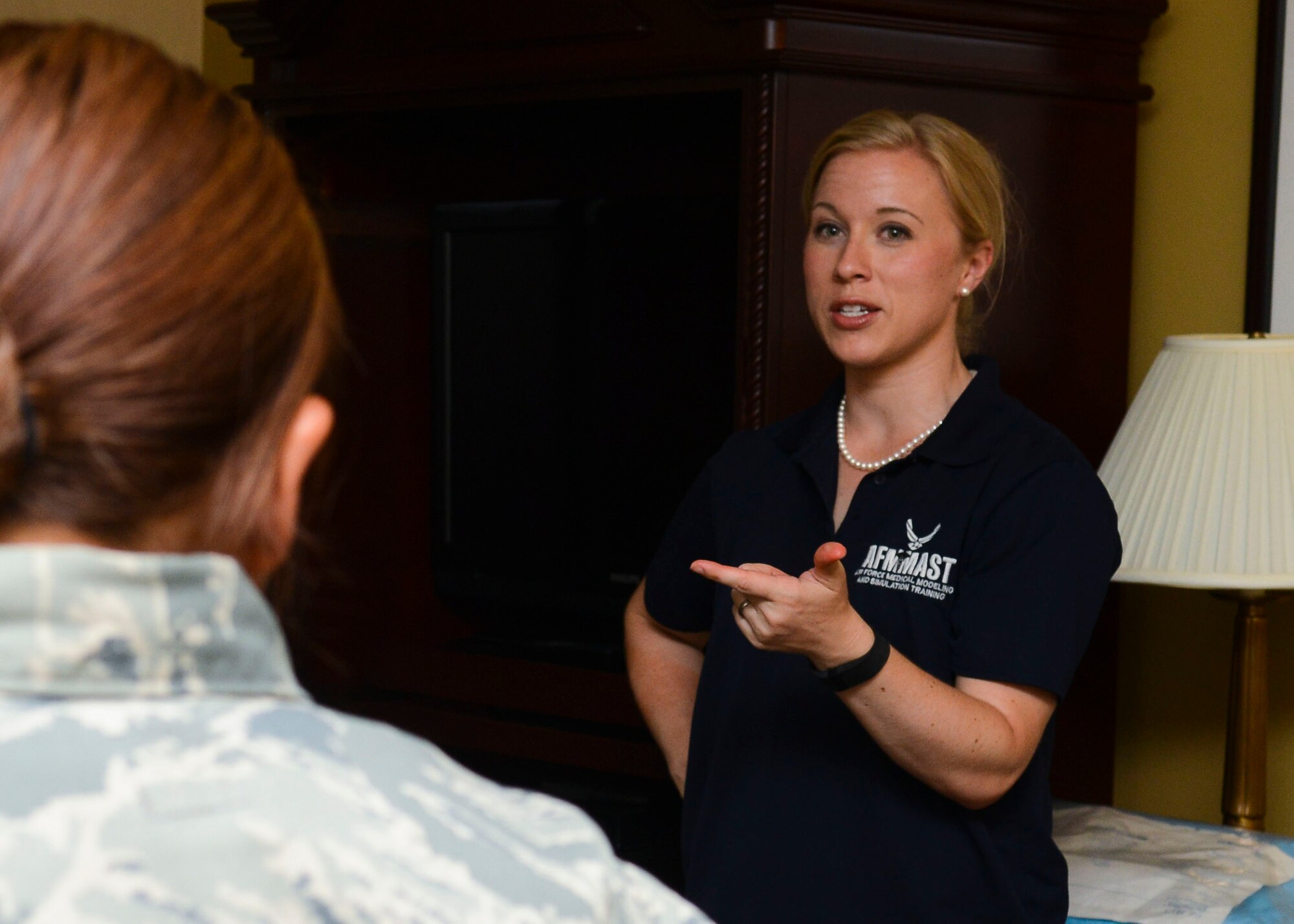 Missy Hanley, 31st Medical Group medical simulation operator, speaks with participants after a simulated birth exercise, Aug. 13, 2015, at Aviano Air Base, Italy. Simulation exercises incorporate on-the-spot challenges to open up dialogue and encourage all members to ask questions. (U.S. Air Force photo by Senior Airman Austin Harvill/Released)