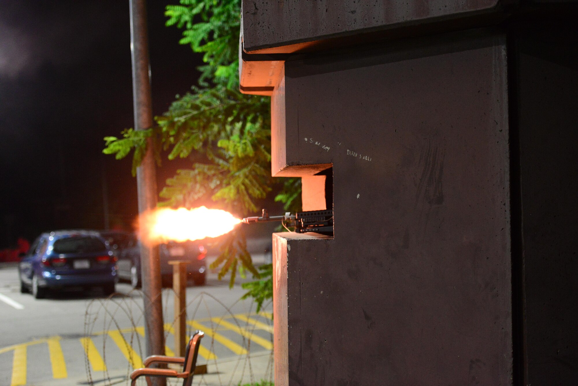 Airman Alexander Schrom, 51st Security Forces Squadron member, fires blanks at opposing forces during an attack on his defensive fighting position during exercise Beverly Midnight 15-03 at Osan Air Base, Republic of Korea, August 20, 2015. During this exercise, wing capabilities such as defending against simulated ground and aerial attacks were tested. (U.S. Air Force photo/Staff Sgt. Amber Grimm)