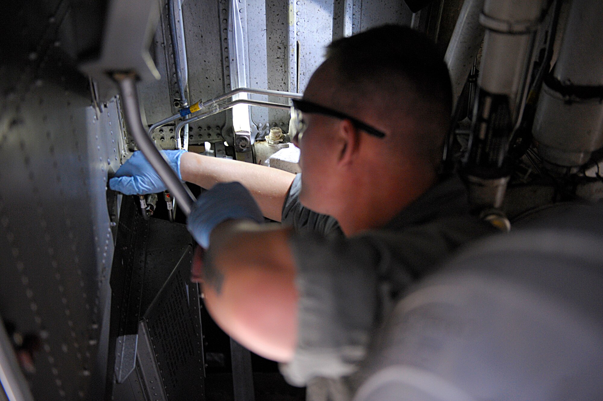Staff Sgt. Ryan LaMonte, 86th Maintenance Squadron hydraulics systems craftsman, replaces the nose landing gear steering control swivel valve on a C-130J Super Hercules assigned to the 37th Airlift Squadron, Ramstein Air Base, Germany, Aug. 17, 2015, at Otopeni Air Base, Romania. Approximately 80 personnel traveled to Otopeni Air Base to participate in Carpathian Summer, a bilateral training exercise designed to increase readiness and interoperability between the U.S. and Romanian air forces. The U.S. Air Force transferred authority to NATO of the three C-130Js participating in the exercise. This Transfer of Authority is a standard procedure that will serve to enhance interoperability and readiness to conduct combined air operations with Romania and NATO. The TOA will end at the conclusion of the exercise. (U.S. Air Force photo/Senior Airman Timothy Moore)