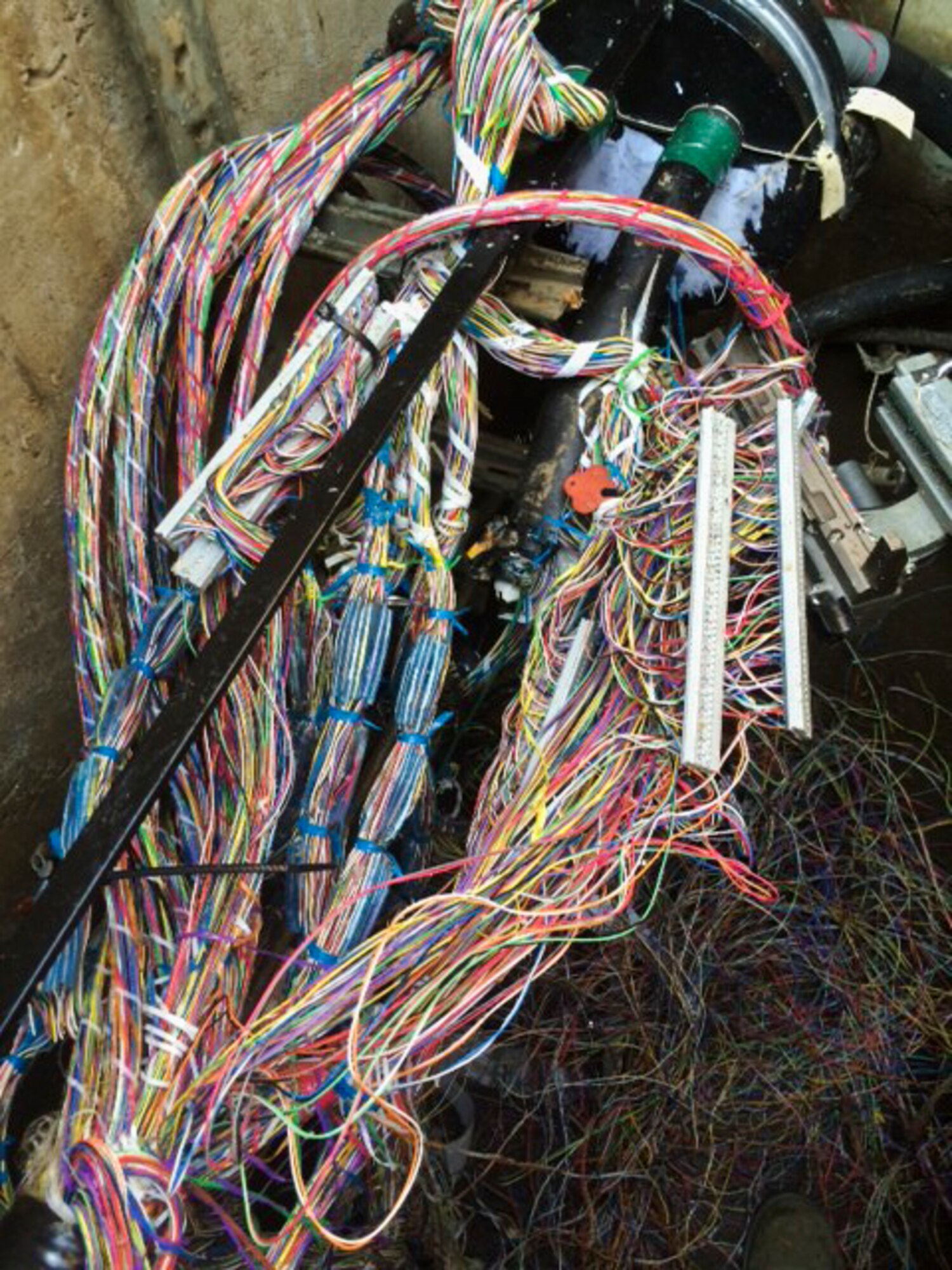 A bundle of wires is about to be spliced at Yokota Air Base, Japan. On August 7, 2015, the 374th Communications Squadron cable and antenna shop discovered that there were problems with a major communications cable that runs across the flight line and powers communications for the Air Traffic Control Tower, Radar Approach Control, airfield systems, the Combat Arms Training and Marksmanship building and the alarms for the munitions storage building. (Courtesy photo)