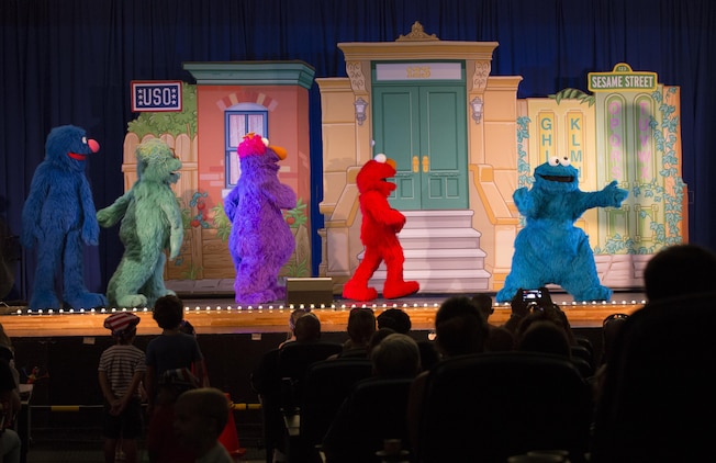 Elmo and friends perform at the Sakura Theater as part of United Services Organization Experience for Military Families at the Sakura Theater aboard Marine Corp Air Station Iwakuni, Japan, Aug. 14, 2015. Military kids can move anywhere from six to nine times before they hit high school. Bringing Elmo and friends directly to them is like bringing a little bit of home away from home.