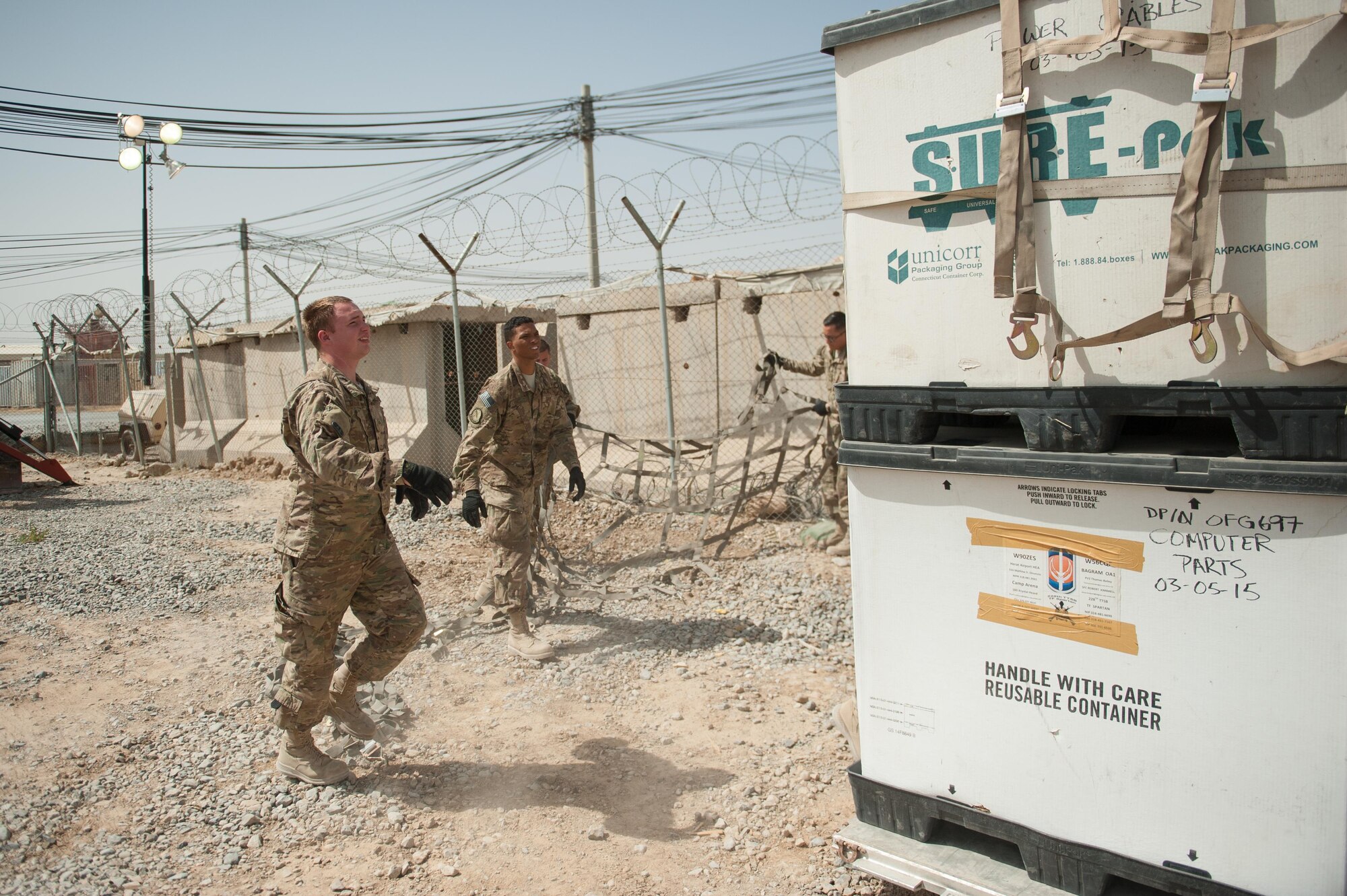 U.S. Air Force Staff Sgt. Cody Madison, 451st Expeditionary Support Squadron Central Command Material Recovery Element joint inspector, removes cargo straps from a pallet at Kandahar Airfield, Aug. 15, 2015. Madison is responsible for identifying, storing and redeploying assets to the U.S. or disposing of items located throughout Afghanistan. (U.S. Air Force photo by Tech. Sgt. Joseph Swafford/Released)