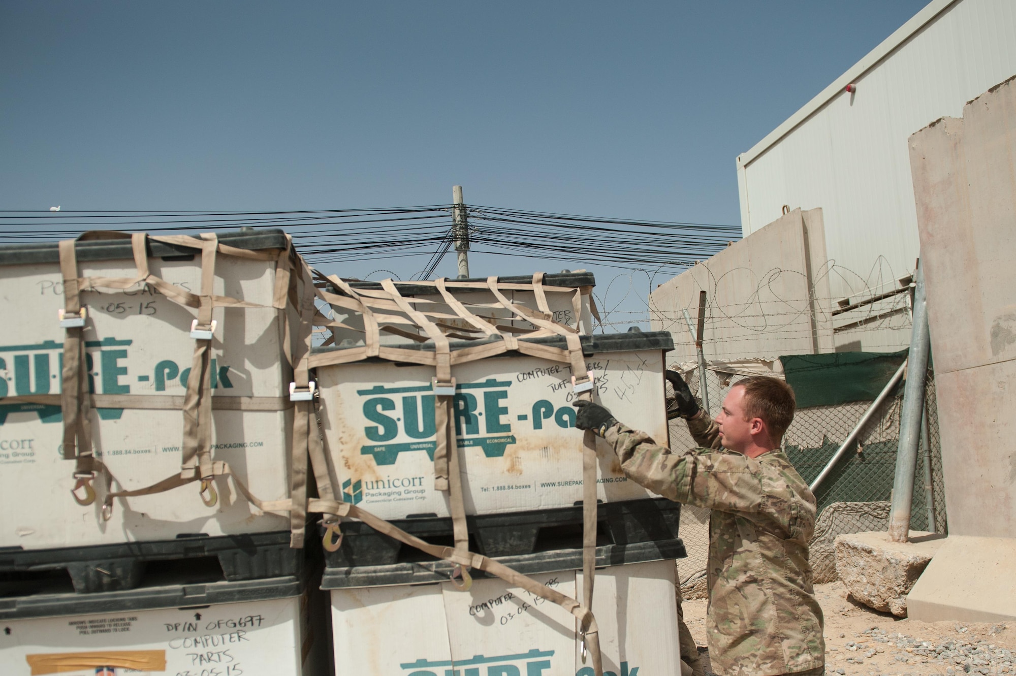 U.S. Air Force Staff Sgt. Cody Madison, 451st Expeditionary Support Squadron Central Command Material Recovery Element joint inspector, removes cargo straps from a pallet at Kandahar Airfield, Aug. 15, 2015. Madison is responsible for identifying, storing and redeploying assets to the U.S. or disposing of items located throughout Afghanistan. (U.S. Air Force photo by Tech. Sgt. Joseph Swafford/Released)