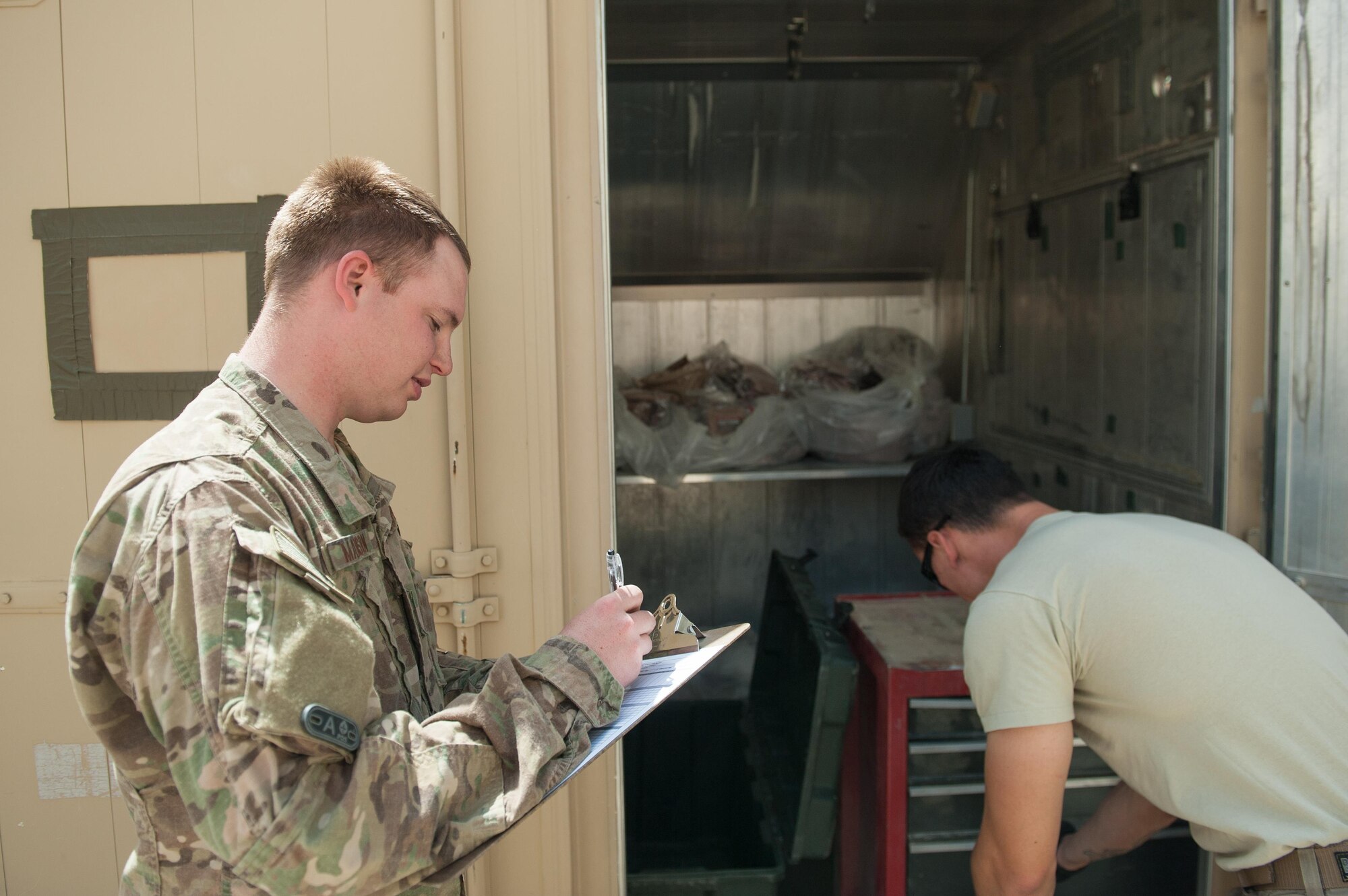 U.S. Air Force Staff Sgt. Cody Madison, 451st Expeditionary Support Squadron Central Command Material Recovery Element joint inspector, inventories assets at Kandahar Airfield, Aug. 15, 2015. Madison is responsible for identifying, storing and redeploying assets to the U.S. or disposing of items located throughout Afghanistan. (U.S. Air Force photo by Tech. Sgt. Joseph Swafford/Released)