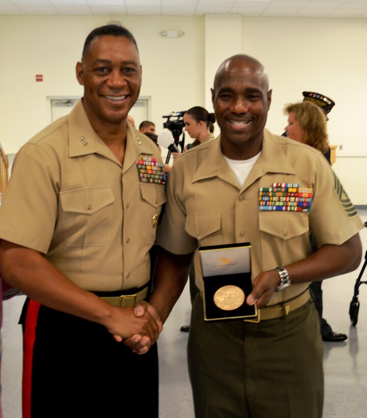Major General Crenshaw and MGySgt Joseph G. Lawrence take time for a photo after MGySgt Joseph G. Lawrence accepted a Congressional Gold Medal on behalf of Joseph F. Lawrence (USMC WWII) during a medal presentation to families of Montford Point Marines.