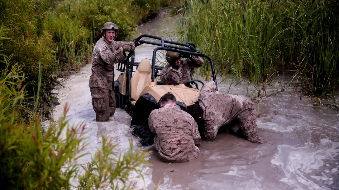 Marines with Force Reconnaissance Platoon, 22nd Marine Expeditionary Unit, utilize a wench on the front of a Polaris Rzr tactical vehicle after driving into a fording pit during an all-terrain vehicle course at Marine Corps Base Camp Lejeune, North Carolina, Aug. 18, 2015. The Marines were taught how to use the wench just a few hours before, and were able to apply the skill while stuck in a real situation.