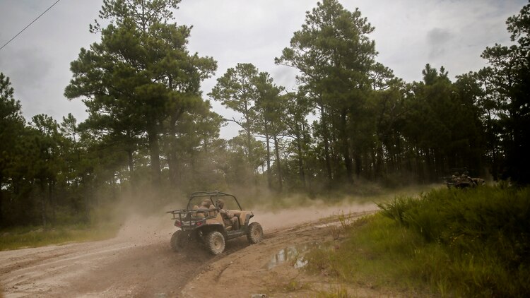 Marines with Force Reconnaissance Platoon, 22nd Marine Expeditionary Unit, drive the Polaris Rzr tactical vehicle along tank trails during an all-terrain vehicle course at Marine Corps Base Camp Lejeune, North Carolina, Aug. 18, 2015. Marines drove the Polaris Rzr tactical vehicles through sand, mud and uneven terrain to gain experience with handling the vehicle.