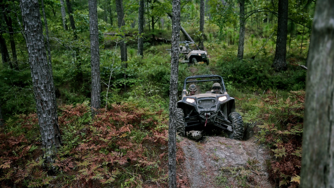 Marines with Force Reconnaissance Platoon, 22nd Marine Expeditionary Unit, drive the Polaris Rzr tactical vehicle along all-terrain vehicle trails during an all-terrain vehicle course at Marine Corps Base Camp Lejeune, North Carolina, Aug. 18, 2015. Marines drove the Polaris Rzr tactical vehicles through sand, mud, uneven terrain, and hills to gain experience with handling the vehicle.