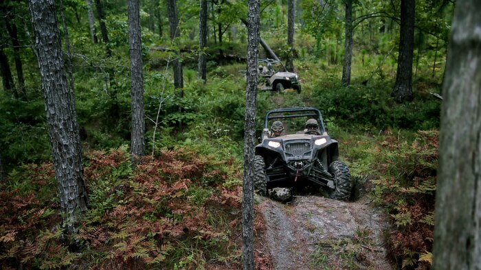 Marines with Force Reconnaissance Platoon, 22nd Marine Expeditionary Unit, drive the Polaris Rzr tactical vehicle along all-terrain vehicle trails during an all-terrain vehicle course at Marine Corps Base Camp Lejeune, North Carolina, Aug. 18, 2015. Marines drove the Polaris Rzr tactical vehicles through sand, mud, uneven terrain, and hills to gain experience with handling the vehicle.
