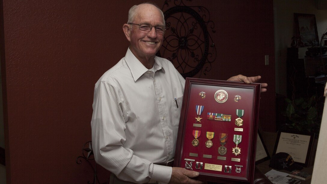 Homer "Mike" Jenkins, a Marine Vietnam veteran, holds a shadow box highlighting his service in the Marines at his home near Hughes Springs, Texas, June 5, 2015. Jenkins did two tours in Vietnam, the first as an advisor to Vietnamese troops; his second tour, he was a company commander leading Marines in combat. 