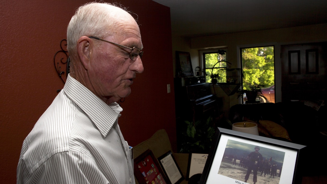 Homer "Mike" Jenkins, a Marine Vietnam veteran, holds a photo of himself when he was awarded the Silver Star Medal for his actions in Vietnam at his home near Hughes Springs, Texas, June 5, 2015. Jenkins was deployed to Vietnam as an advisor to Vietnamese troops and a second time leading his Marines in combat. 